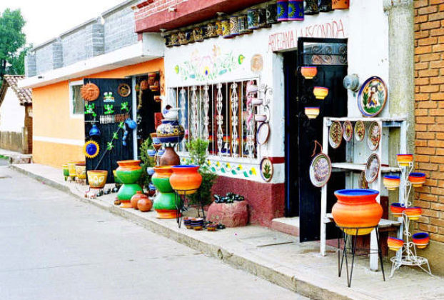 Colorful crafts fill doorways and sidewalks in the streets of Capula.