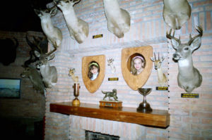 Children enjoy peeping through holes next to mounted heads in the "House of the Hunter" at the Museum of the Desert in Saltillo.