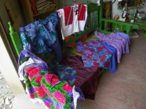 Beautiful old huipil blouses too tattered to wear aqre recycled as authentic regional costumes for Dolores Leycegui's collection of Frida Kahlo dolls, handcrafted in Oaxaca, Mexico © Alvin Starkman, 2012