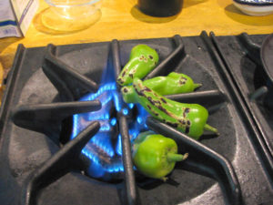 Chiles are blistered over an open flame to make this Mexican dish. When wrapped in a towel and left to cool in a plastic bag, they can be easily peeled. © Alvin Starkman 2008