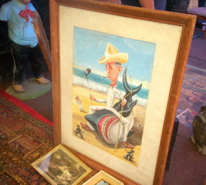 This funny character is wrestling a shark on a beach-traditional '50s comic style painting at La Lagunilla.