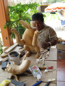 An uncle fills cracks resulting from the drying process at Jacobo Angeles' workshop in Mexico. © Alvin Starkman 2008