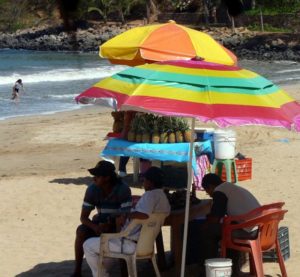 Chacala is small, but the relaxed ambience is also its charm. Tourists and merchants alike enjoy this Nayarit beach beneath colorful umbrellas. © Christina Stobbs, 2009