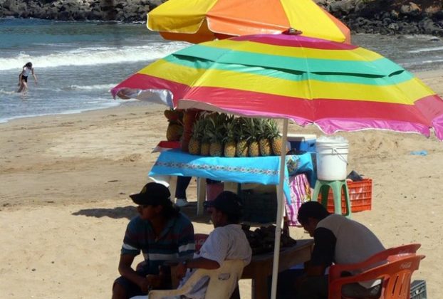 Chacala is small, but the relaxed ambience is also its charm. Tourists and merchants alike enjoy this Nayarit beach beneath colorful umbrellas. © Christina Stobbs, 2009