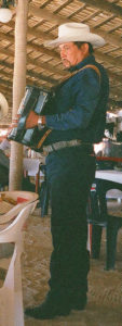 An itinerant musician plying his trade at the restaurant at Pichilingue beach