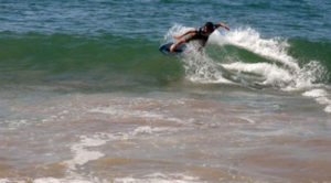 A young Mexican skimboarder executes a difficult move on the shore of Melaque, Jalisco. © Gerry Soroka, 2010