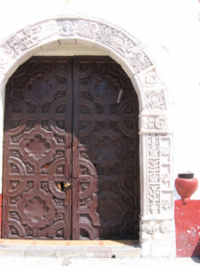 The ornate door in the austere facade of San Esteban Church. The beauty of Mexico's stately old churches inspires admiration. © Julia Taylor, 2008