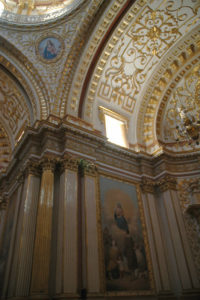 In the Sanctuary of Our Lady of Guadalupe in Zacatecas, the walls of the chapels, a delight of golds, creams, crystal chandeliers and delicate filigree, also display religious paintings and murals. © Jane Ammeson, 2009
