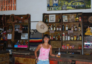 Yusfia Jiménez enjoys a cold Mexican beer at Los Azteca Hacienda Mexicana's unique bar. Los Azteca, which dates back to the 1700s and is also a winery, is a lienzo charro, where Mexican style rodeos are held. © Jane Ammeson 2009