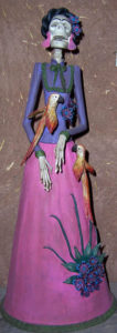 A ceramic Catrina that pays homage to Mexican icon Frida Kahlo. Inspired by the caricatures of lithographer Jose Guadalupe Posada, the elegant Catrina has her origins in Day of the Dead celebrations.This piece was exhibited in Chapala's annual Feria Maestros del Arte. © Marianne Carlson, 2008