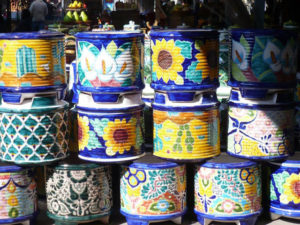 If you decide to visit the enchanting, Mexican town of La Peñita, make sure you attend the tianguis, a gigantic every Thursday market with close to one hundred merchants selling everything from fruits and vegetables to artisan crafts, in and around the main town square. These hand-crafted ceramic flower pots entice shoppers. © Christina Stobbs, 2009