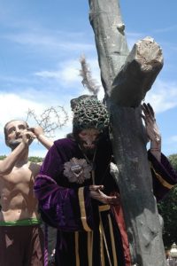 It begins with the parish priest carrying Father Alfaro's standard… Soldiers, then little girls in white dresses, some with angel wings, preceed the penitents dressed in rough purple cloth. The first staue to emnerge is a huge figure of Jesus Nazareno carrying the cross. He is followed by San Roque, San Juan, Mary Magdalene, Veronica and Maria Cleofas.