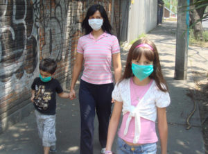 The author's wife and children take a short stroll on the street in Mexico City to relieve themselves of "cabin fever." © Anthony Wright, 2009