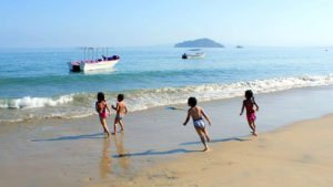 Children frolic on th beach of Mexico's beautiful Jaltemba Bay. © Christina Stobbs, 2011