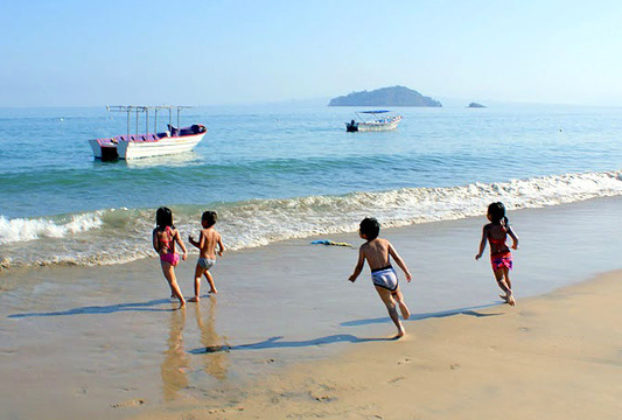 Children frolic on th beach of Mexico's beautiful Jaltemba Bay. © Christina Stobbs, 2011