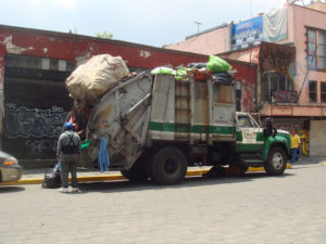 In Mexico City, it is sometimes preferable to take your trash directly to a garbage truck on the street than wait for the service to pay a visit to your home. © Anthony Wright, 2009