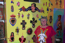 Marianne Carlson in front of a wall display of punched tin ornaments from Guanajuato © Judy Dykstra-Brown, 2006