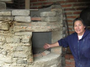 Martin Navarro's mother proudly points to the oven-in her backyard-where her son fires his masterpieces © John Pint, 2012