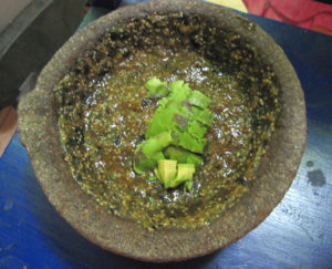 Smoky salsa verde asada (Mexican green sauce from the grill) served in its molcajete, a morter of volcanic stone in which the ingredients are ground. © Alvin Starkman 2008