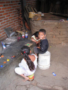 José María and Cecilia's grandchildren play around the cold kiln.