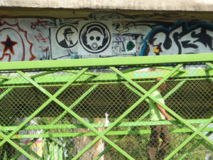 Distinct stencil grafitti imagery amid a sea of scrawling in a Mexico City pedestrian bridge. © Anthony Wright, 2009