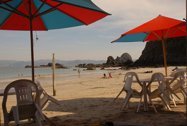 Waiting for the crowds, umbrellas frame a popular snorkling location at Tenacatita on Mexico's Pacific coast. © Gerry Soroka, 2009