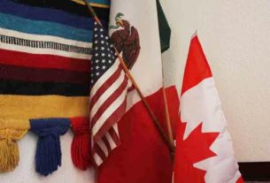 The Mexican, American, and Canadian (the MAC in Liga MAC) flags are on display in the organizations office © Mariah Baumgartle, 2012