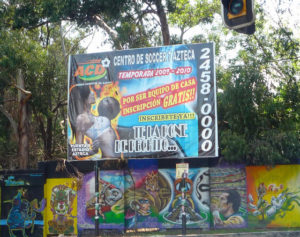 A popular billboard looms over graffiti murals on the Estadio Azteca (Aztec Stadium) in Mexico City. © Anthony Wright, 2009