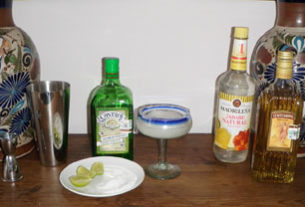 Ingredients for the classic margarita include tequila, Cointreau, the juice of fresh limes (limones) and bar syrup, a sugar-water mixture. Salt adorns the rim of the glass. © Daniel Wheeler, 2010