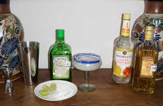 Ingredients for the classic margarita include tequila, Cointreau, the juice of fresh limes (limones) and bar syrup, a sugar-water mixture. Salt adorns the rim of the glass. © Daniel Wheeler, 2010
