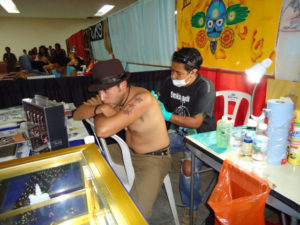 Tattoo artists at the Tattoo Fest in Oaxaca, Mexico, use masks and gloves for hygiene. © Alvin Starkman, 2011