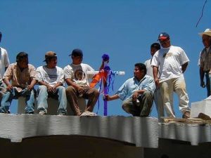 As part of the traditional Day of the Holy Cross celebration on May 3, construction workers from Ajijic's The Little Company place a decorated cross on the roof of their current project, The Swan Inn, a B&B being created from two older existing buildings.