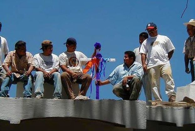 As part of the traditional Day of the Holy Cross celebration on May 3, construction workers from Ajijic's The Little Company place a decorated cross on the roof of their current project, The Swan Inn, a B&B being created from two older existing buildings.