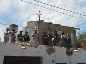 The contractor or the owner of the project raises a toast to the Cross, the safety of the crew and the hope of steady work for the coming year.