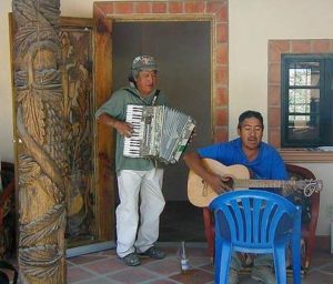 Music is a part of every work day for the construction industry. Here, two of the workers play and sing favorite songs on the terrace of the poolside guest house during the celebration on May 3.
