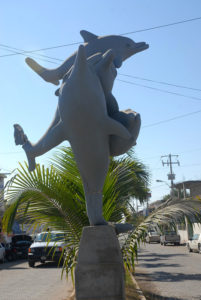 Intertwined dolphins, including one with a battered tailfin, guard Melaque's main street. © Gerry Soroka, 2009