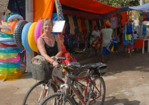 Vera stands by with our bikes, the only way to go. In the background, the tianguis, or moving street market, offers all kinds of wares © Gerry Soroka, 2009