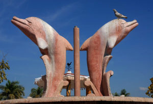 A rooster, a pigeon and the disapproving dolphins of the zócalo in Melaque, a Jalisco beach town. © Gerry Soroka, 2009