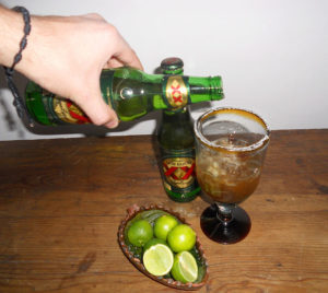 Pour the 'chirimico' over the ice, then slowly add the beer. The michelada is a very popular drink among Mexico's young adults. © Daniel Wheeler, 2011