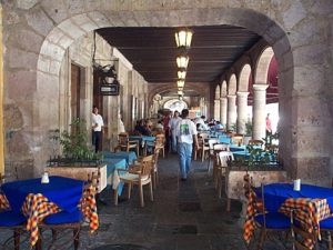 The portico on the north side of the zocalo features the tables for coffee drinking. Even after noon in the heat, coffee is the preferred beverage.