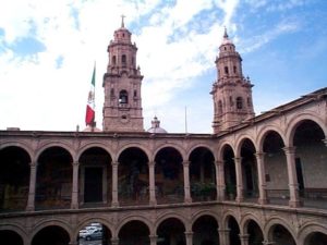 Looking south from the interior of the Palacio de Gobierno you can see the towers of the cathedral in the zocalo.