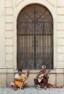 Guitarists sing and play on a city street in Oaxaca, Mexico. © Alan Cogan, 1997