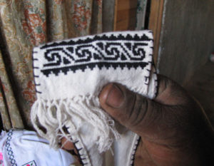 Michacan's traditional guanengo blouses and other needlepoint garments didn't always have the bright colors they do today. Until the 1980s, they had much simpler designs in black and white, like this miniature shawl. © Travis Whitehead, 2009