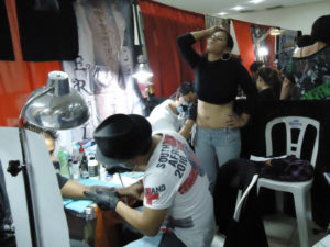 Getting a tattoo can hurt, as seen at the Tattoo Fest in Oaxaca, Mexico © Alvin Starkman, 2011