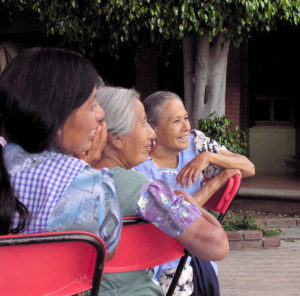 Ladies at the baptism watch the festivities from the sidelines. © Norma Hawthorne 2008