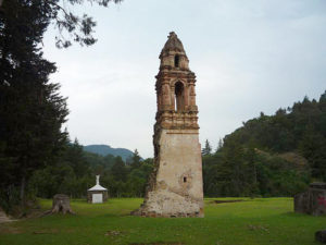 A church tower protruding from the ground offers the incongruous spectacle that is the "Iglesia Enterrada," surrounded by forest that has since reclaimed this section of Tlalpujahua. Michoacan following a mining disaster in 1937. © Anthony Wright, 2009