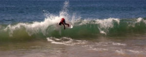 A daring Mexican skimboarder catches a wave on the shore of Melaque, Jalisco. © Gerry Soroka, 2010