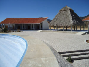 Above the petrified mineral cascades at Hierve el Agua, a large, modern swimming pool invites explorers to cool off before enjoying a meal in one of the dozen or so restaurants alongside a thatch-roofed palapa © Alvin Starkman, 2012