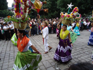 A traditional calenda, or "parade," with a live band, dancers in colorful regional dress, and fireworks in downtown Oaxaca, Mexico. © Alvin Starkman, 2011