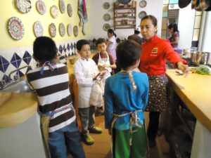 Students at Chef Pilar Cabrera's Casa de los Sabores Cooking School meet the renowned chef herself in her first class for children at the prestigious culinary school in Oaxaca, Mexico. © Alvin Starkman, 2011